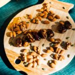 dates and almonds on a wooden platter