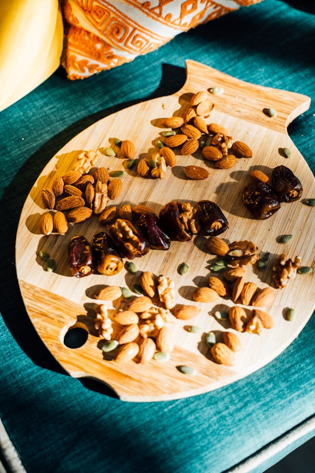 dates and almonds on a wooden platter