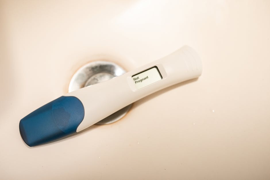 Close-up of a digital pregnancy test showing a negative result on a white surface.
